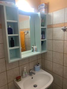 a bathroom with a sink and a medicine cabinet at Patmos Villas in Grikos