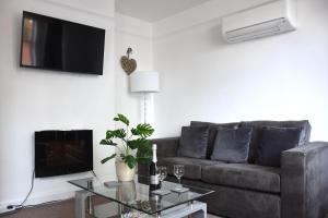a living room with a couch and a table at Friarscroft Lodge Holiday Home in Wymondham