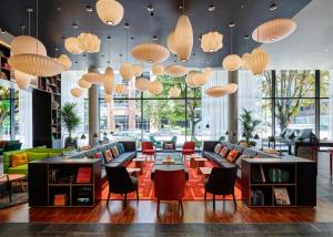 a lobby with couches and tables and lamps at citizenM Seattle South Lake Union in Seattle