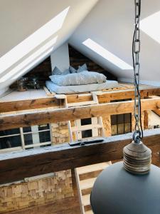 a room with a bed on top of a roof at Loft im Herzen der Stadt in Fürstenwalde