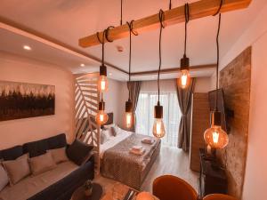 a living room with a couch and a bed at Milmari MM L24 in Kopaonik +36 photos