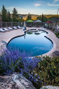 a swimming pool with blue water in a yard at Timberline Condominiums Studio Deluxe Unit 217 in Snowmass Village