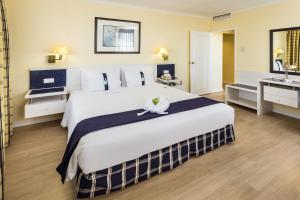 a hotel room with a large bed and a sink at Holiday Inn Lisbon by IHG in Lisbon