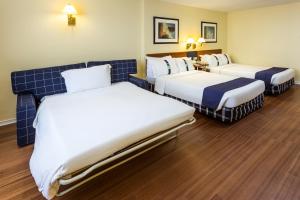 a hotel room with two beds in a room at Holiday Inn Lisbon by IHG in Lisbon
