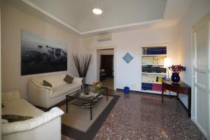 a living room with a couch and a table at Baroque Modica in Modica