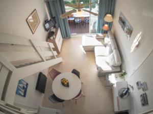 an overhead view of a living room with a couch and a table at LES SOLEILLADES Parking 200 mètres plage in Marsillargues