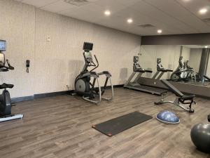 a gym with several treadmills and elliptical machines at Holiday Inn Baton Rouge-South, an IHG Hotel in Baton Rouge