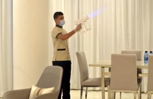 a man with a mask holding a toy gun at The Lodge Suites in Manama