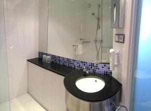 
a bathroom with a sink and a toilet at Holiday Inn Express Bilbao Airport, an IHG Hotel in Derio
