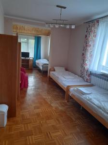 Posteľ alebo postele v izbe v ubytovaní Pensjonacik Zacisze