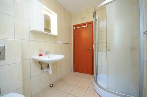 a bathroom with a sink and a shower at Apartments and Rooms Stipe in Podstrana +37 photos