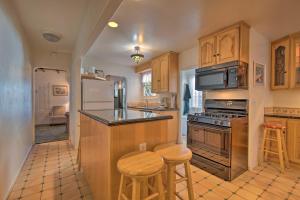 a kitchen with wooden cabinets and a stove top oven at Avalon Escape Everything Within Walking Distance! in Avalon