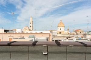 a view of a city with a windmill and buildings at Just Here apartments - La mansarda in Bari