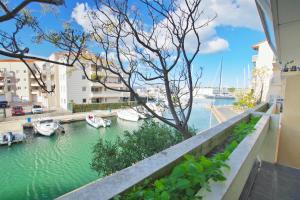 a view from a balcony of boats in a marina at Superbe T2 au calme avec balcon sur la marina - 10 in Canet-en-Roussillon