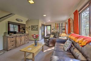 a living room with a couch and a table at Walk to Town: Updated Frisco Cabin w/ 2 Decks! in Frisco