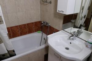 a bathroom with a sink and a toilet and a tub at Apartman UNA Travnik in Travnik