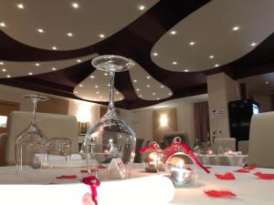 two wine glasses on a table with christmas decorations at Locanda Damaro in Vicenza