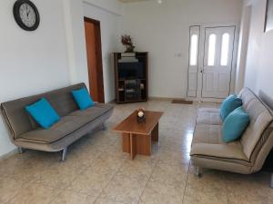 a living room with two couches and a coffee table at Anastasia Apartment in Ayia Marina