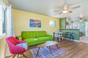a living room with a green couch and a table at Pacific Sunrise in San Diego