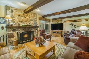 a living room with a fireplace and a tv at Riverside Abode in Thompsonville