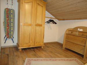 a room with a wooden cabinet and a wooden floor at Ferienwohnung Wingen in Bad Feilnbach