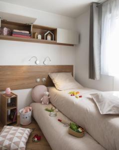 a bedroom with two beds with toys on the floor at PP-Camping Wallersee in Seekirchen am Wallersee