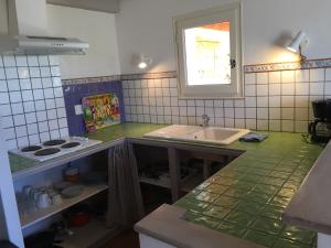 a kitchen with a sink and a counter top at AU PIED DU VENTOUX in Flassan +17 photos