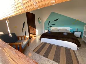 a bedroom with a large bed and a couch at joyhouse in Teguise
