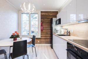 a kitchen with a table and chairs and a window at Villa Härmälä in Tampere