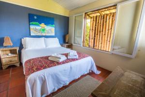 Cama ou camas em um quarto em Pousada Vila Tamarindo Eco Lodge
