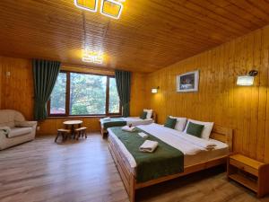 a bedroom with a large bed in a wooden room at Sky Land Camping & Resort in Chişinău +42 photos