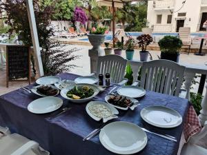 a blue table with plates of food on it at Işıl Suit Apart Otel in Dalyan