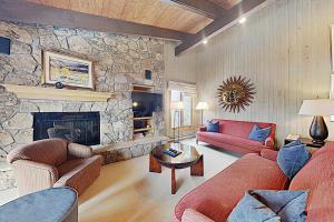 a living room with two couches and a stone fireplace at Timberline Condominiums 3 Bedroom Standard Unit D3A in Snowmass Village