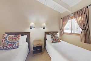 a bedroom with two beds and a window at Timberline Condominiums 3 Bedroom plus loft Deluxe Unit D3E in Snowmass Village +17 photos