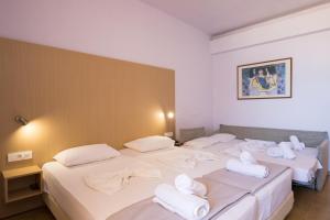 A bed or beds in a room at Atlantis Hotel