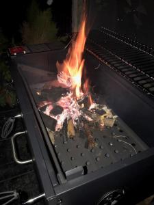 a large grill with a fire in it at Confortable departamento entero in Belén de Escobar