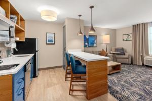 a kitchen and living room with a kitchen and a living room at Candlewood Suites Sumner Puyallup Area by IHG in Sumner