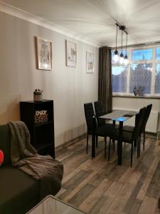a living room with a dining room table and chairs at Palaz 2 - 2 Bedroom Flat in Edmonton