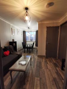 a living room with a couch and a table at Palaz 2 - 2 Bedroom Flat in Edmonton
