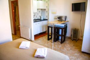 a small kitchen with a table and a microwave at Hotel Lis Mallorca in Palma de Mallorca