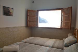 Llit o llits en una habitació de Sunset in the Atlantic Apartamentos Playa de Alojera