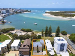 an aerial view of a beach with a boat in the water at Golden Shores Unit 1 21 Landsborough Parade in Caloundra