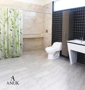 a bathroom with a toilet and a sink and a shower at Anuk Glamping in San Bernardo del Viento +33 photos