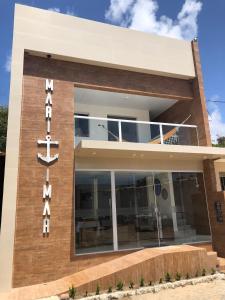 a building with a sign in front of it at POUSADA MARITIMAR in Maragogi