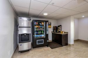 a large refrigerator in a room with a television at Motel 6 Peoria in Peoria