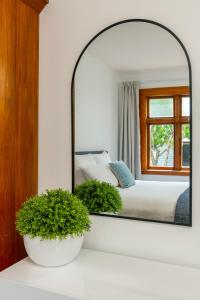 a mirror on a white counter in a bedroom at Stylish on Severne in Blenheim