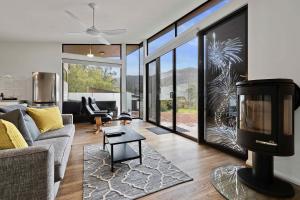 a living room with a couch and a table at Gumnut Villa in Halls Gap