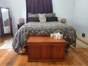 a bedroom with a bed with a wooden table at Killarney Country Living in Killarney