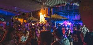 a crowd of people at a party at night at Youth Shack Backpackers Darwin in Darwin +66 photos