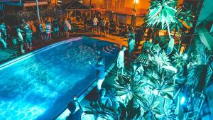 a group of people standing around a swimming pool at Youth Shack Backpackers Darwin in Darwin